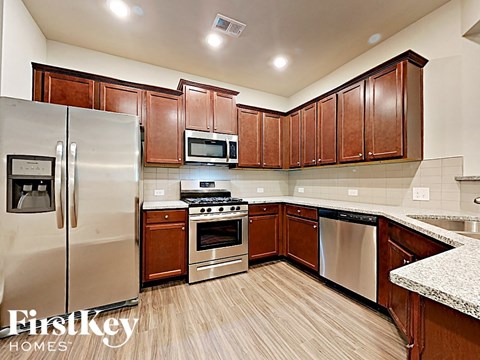 A kitchen with wooden cabinets and stainless steel appliances.