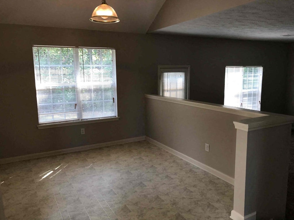 an empty living room with a large window