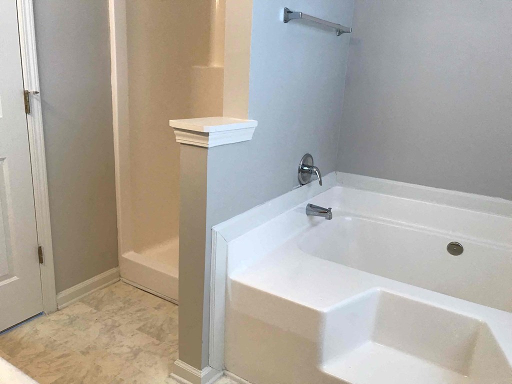 a bathroom with a sink and a tub and a shower