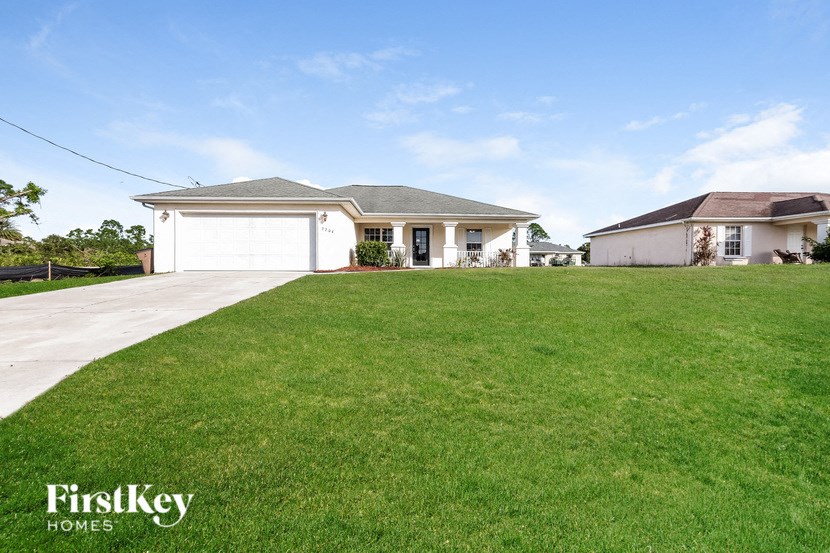 a house with a lawn and a driveway