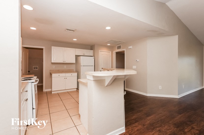 a kitchen with white cabinets and a white counter top