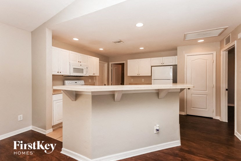 a kitchen with white cabinets and a white counter top