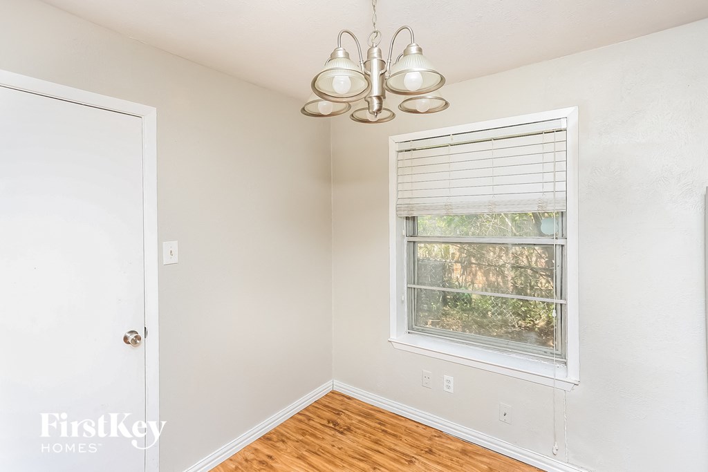 a bedroom with a window and a white door