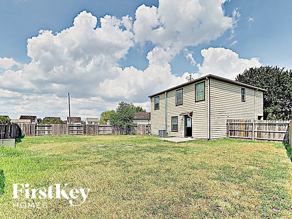 a house in a fisheye view with a yard and a fence