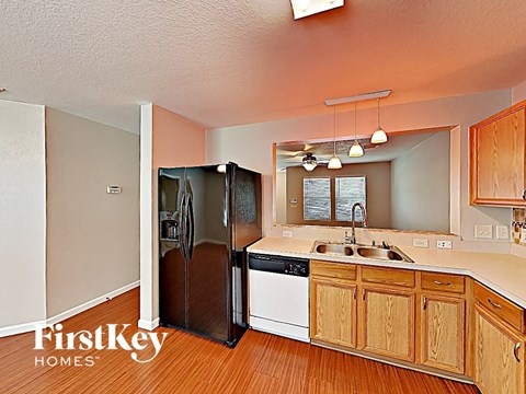 a kitchen with a sink and a refrigerator