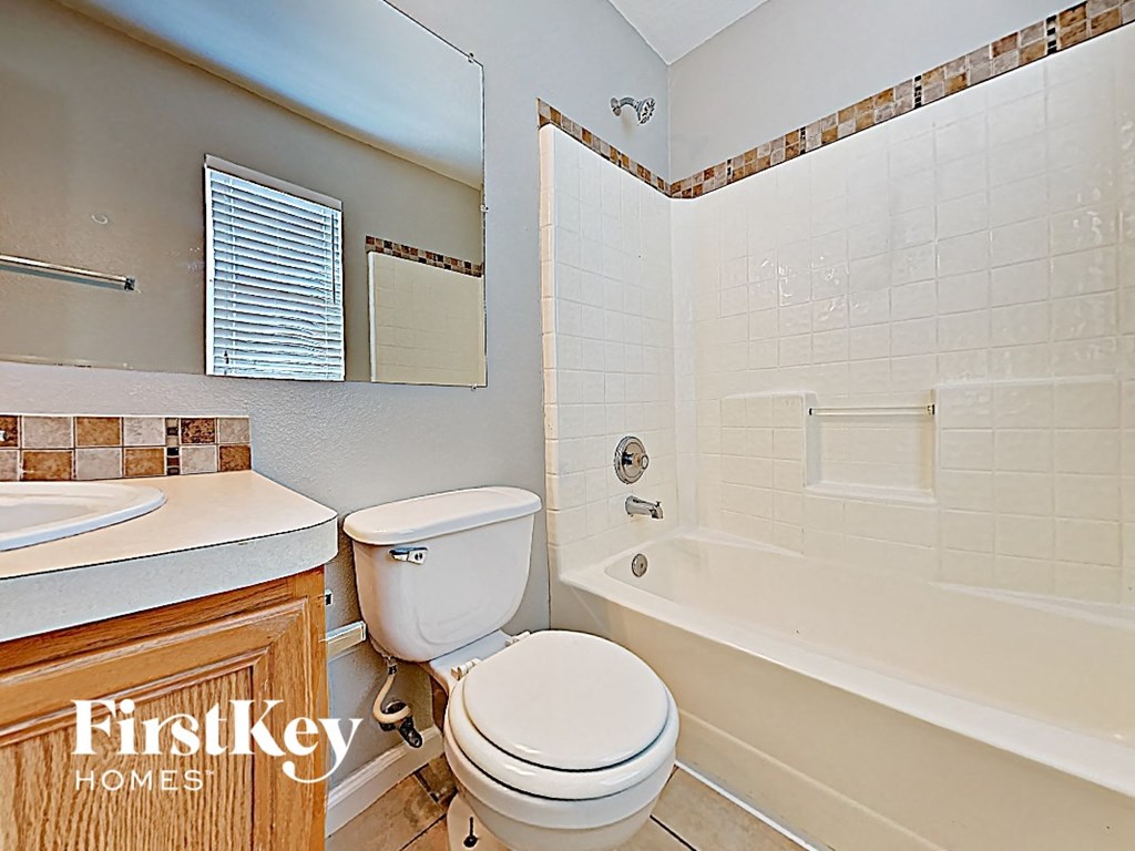 a bathroom with a toilet and a tub and a sink