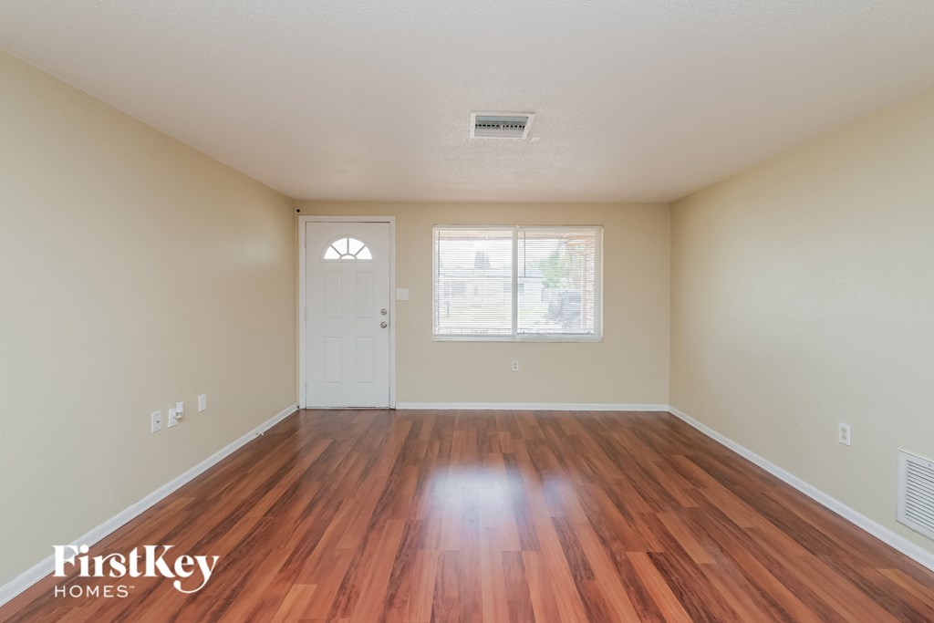 A room with wooden floors and a white door.