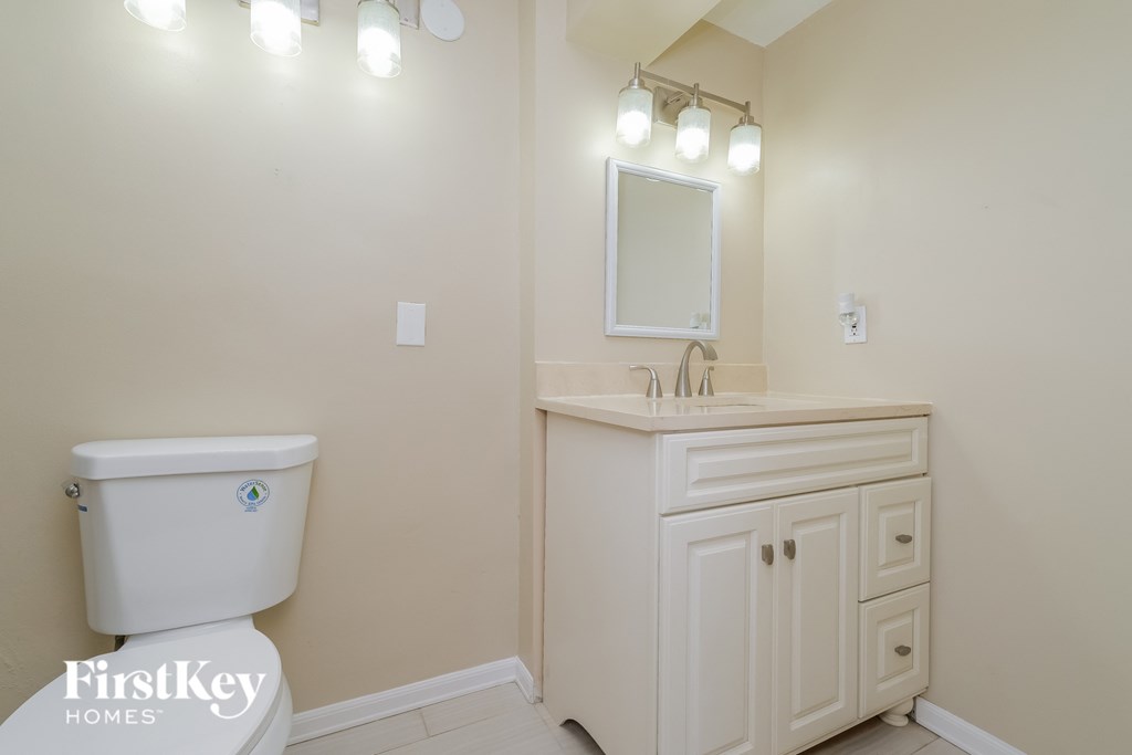 A white toilet sits next to a sink in a bathroom.