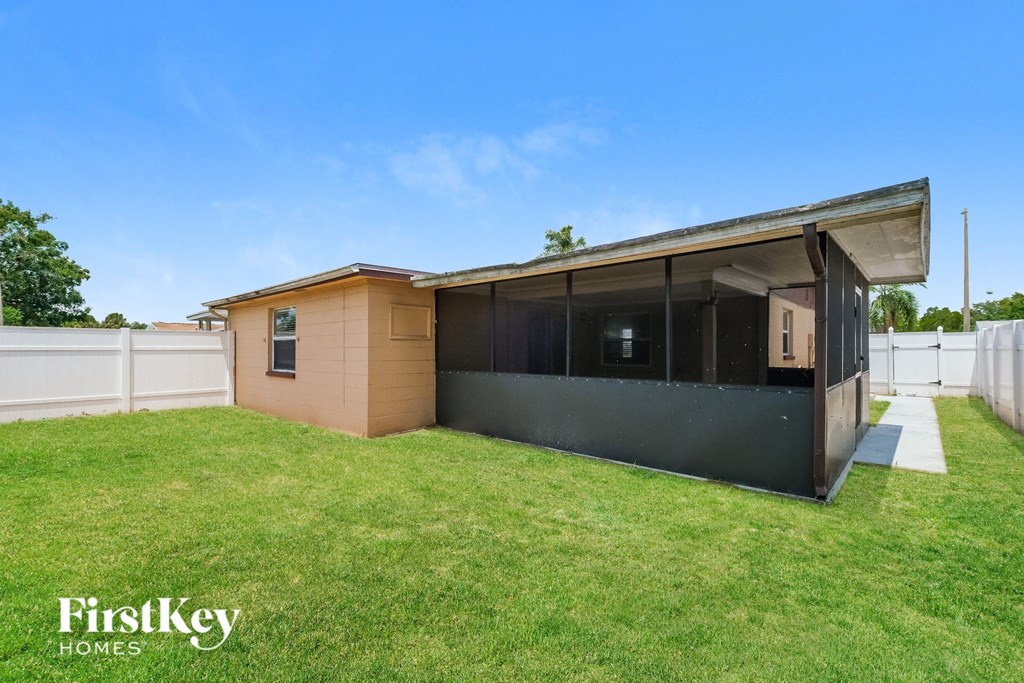 A modern house with a large lawn in front.