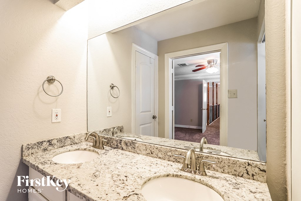 a bathroom with two sinks and a large mirror