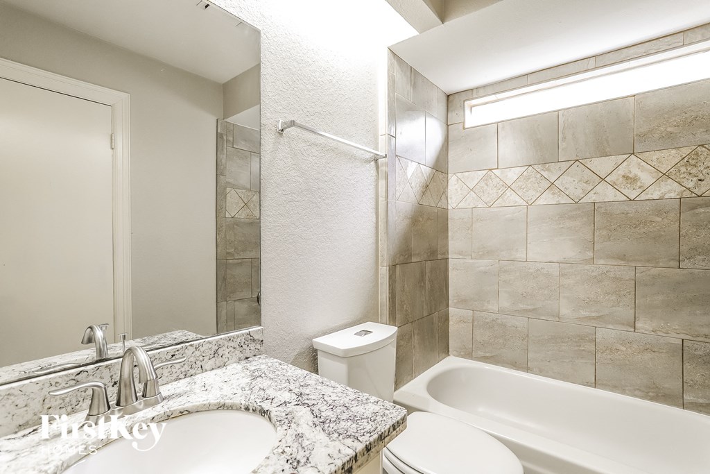 a bathroom with a sink toilet and a shower