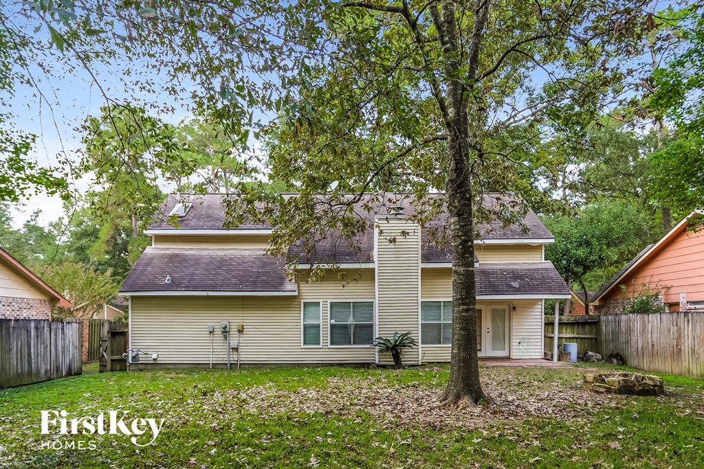 a yellow house with a tree in the yard