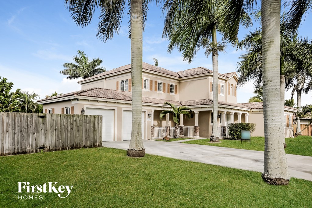 a house with palm trees in front of it