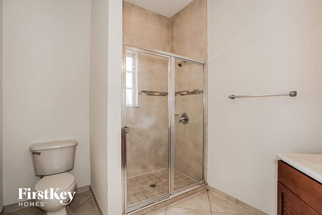 a small bathroom with a shower and a toilet