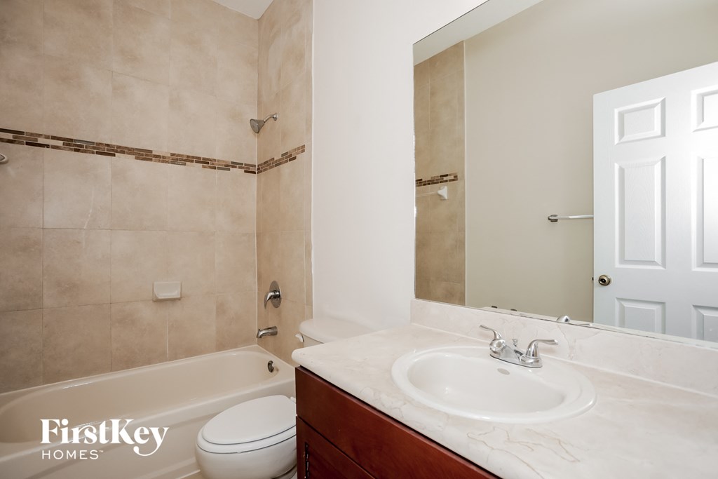 a bathroom with a sink and a toilet and a bath tub
