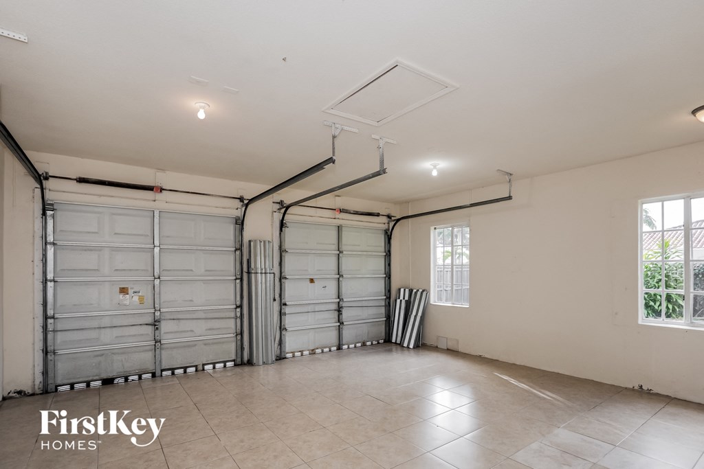 a garage with two garage doors and a window
