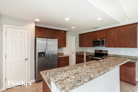 a kitchen with granite counter tops and stainless steel appliances