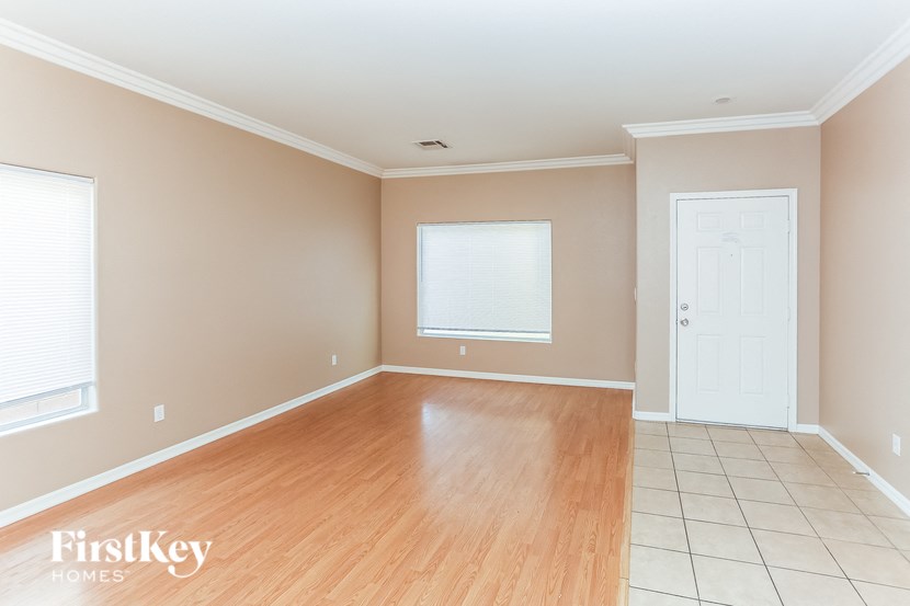 Empty room with wooden floor and white door.
