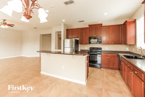 a large kitchen with wooden cabinets and an island