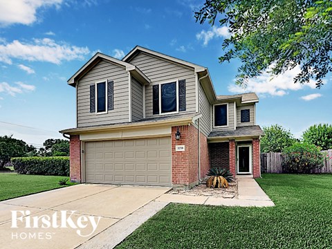 a house with a garage door and a lawn