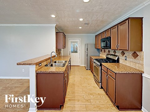 a kitchen with wooden cabinets and granite counter tops