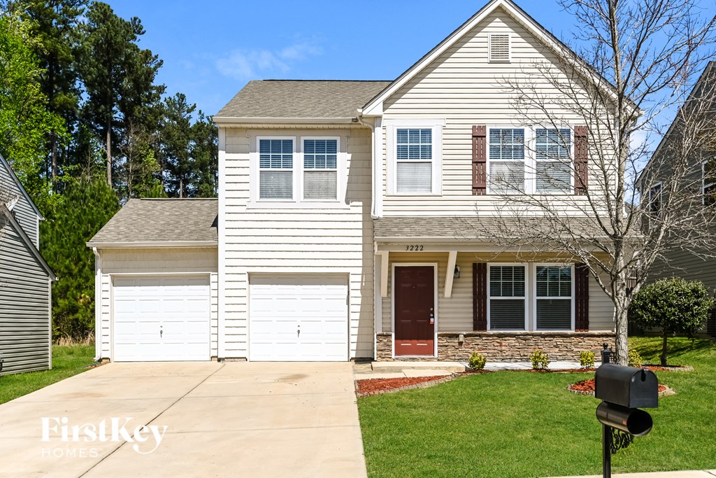 a white house with a garage and a driveway