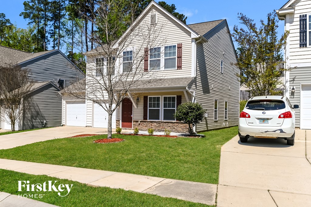 a white car parked in front of a house