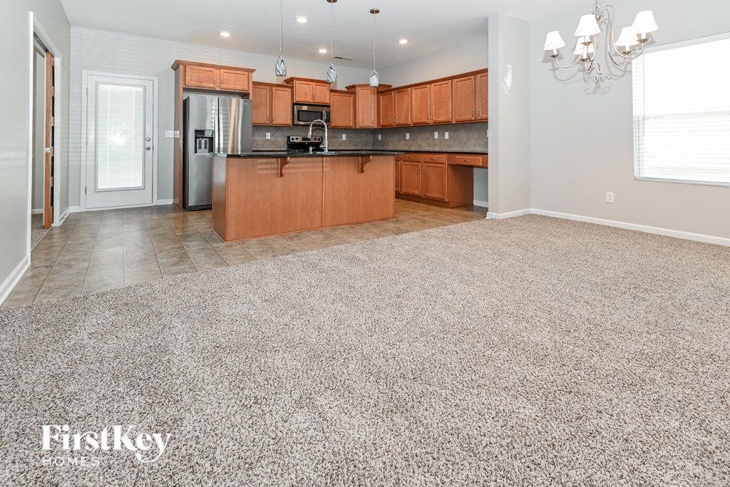 an empty kitchen and living room with a gravel floor