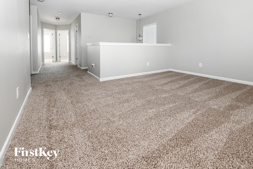 a empty room with a carpeted floor and white walls
