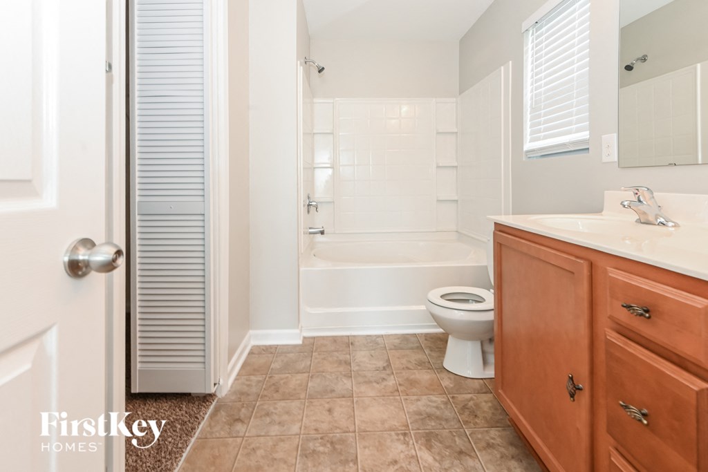 a bathroom with a toilet and a sink and a shower