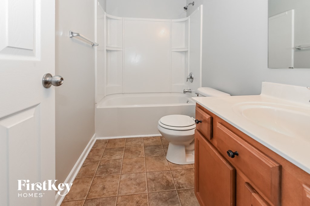 a bathroom with a toilet and a sink and a bath tub