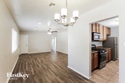 A well-lit kitchen with wooden cabinets and a microwave built into the countertop.