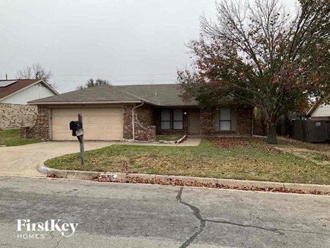 A house with a brown roof and a garage door is shown.