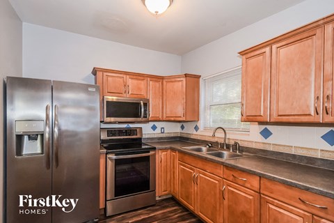 a kitchen with wooden cabinets and stainless steel appliances