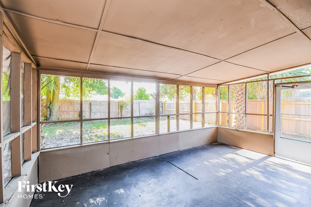 a small room with a lot of windows in a house