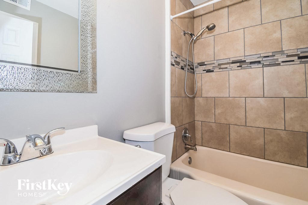 a bathroom with a sink toilet and shower and a tub
