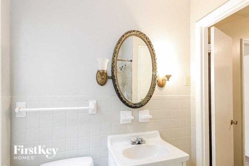 a bathroom with a white sink and a mirror