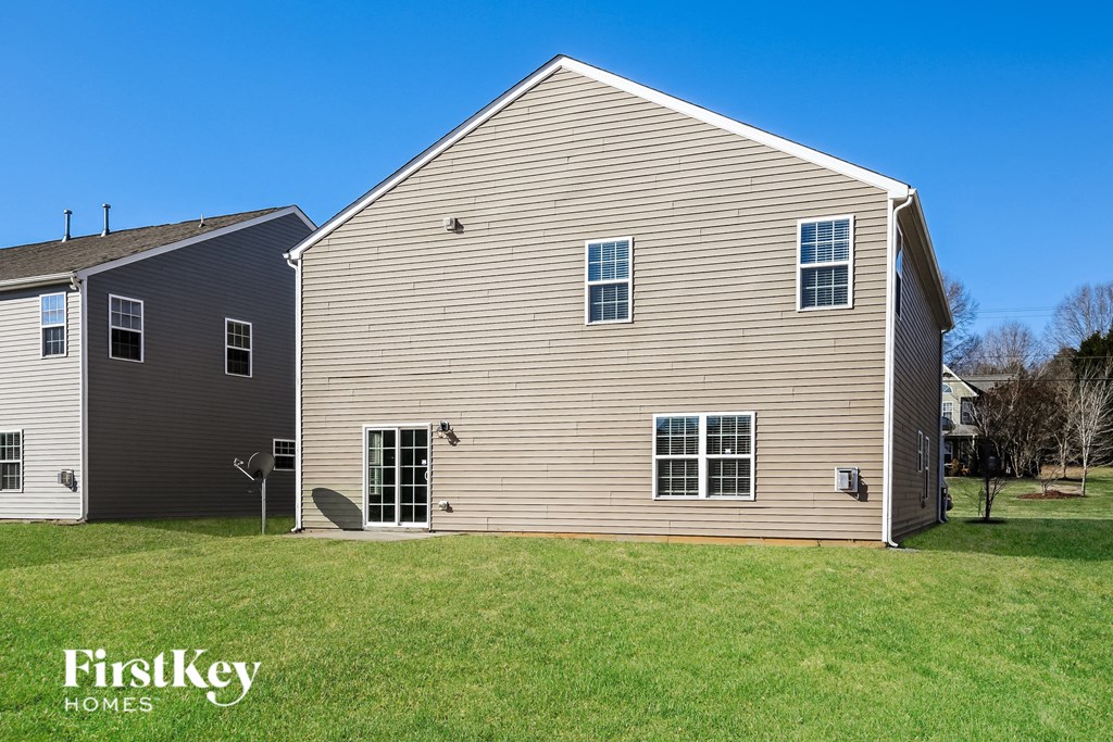 A house with a grey and beige exterior is shown with the words "FirstKey Homes" on the bottom left.