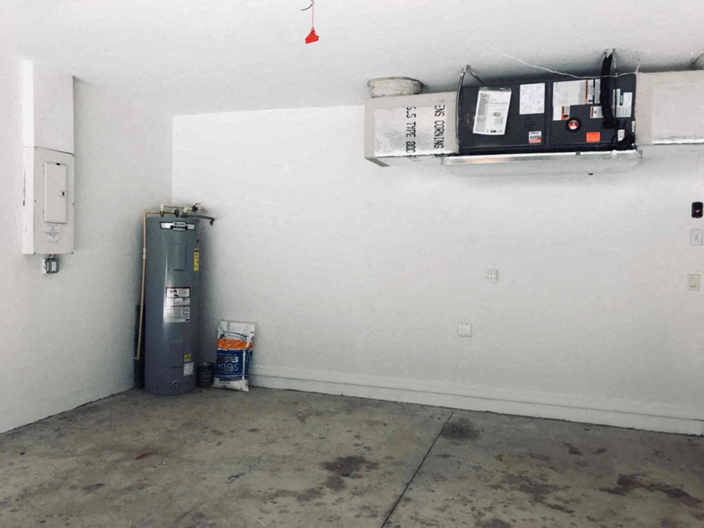 A room with a water heater and a box of tissues.