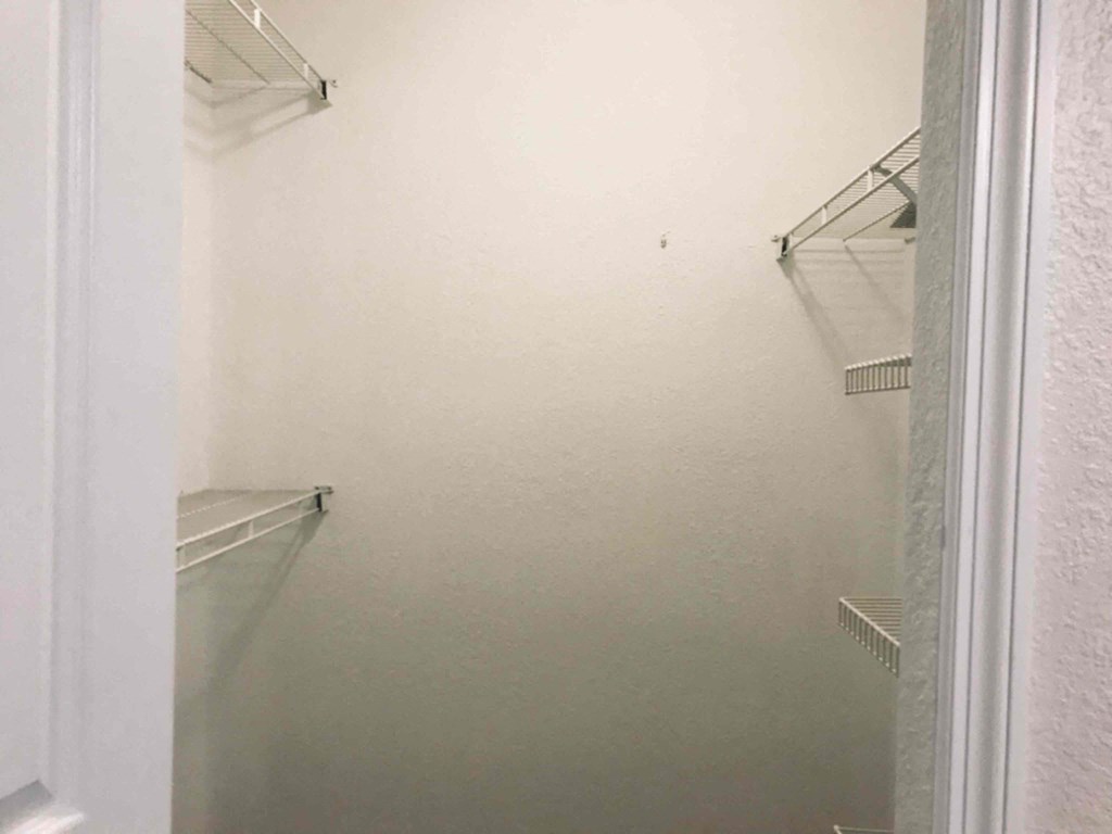 A white refrigerator with a shelf on the left side.