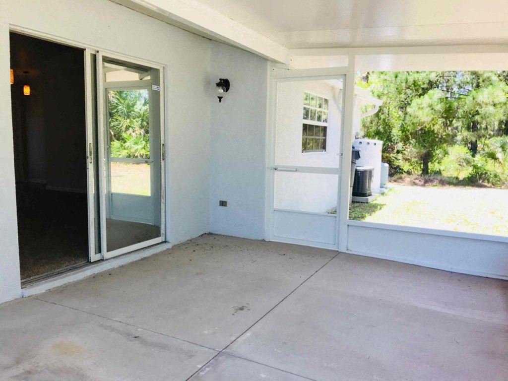 A room with a sliding glass door and a window.