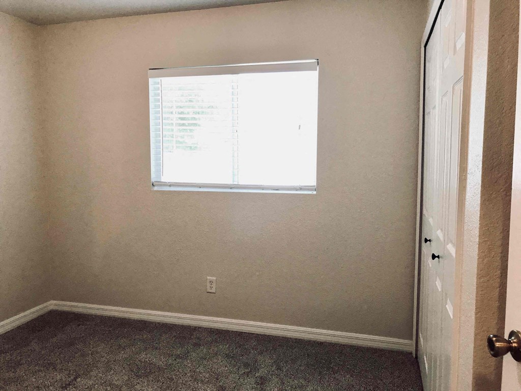 A room with a window and a door.