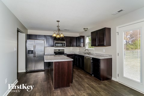 a kitchen with stainless steel appliances and marble counter tops