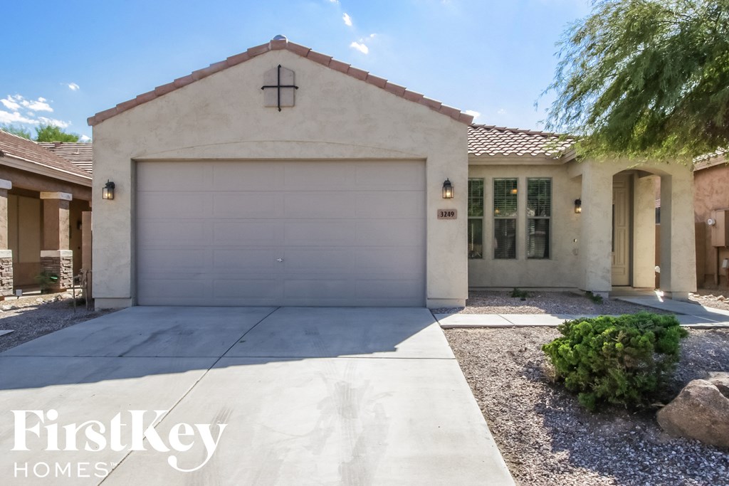A house with a garage door and a driveway.