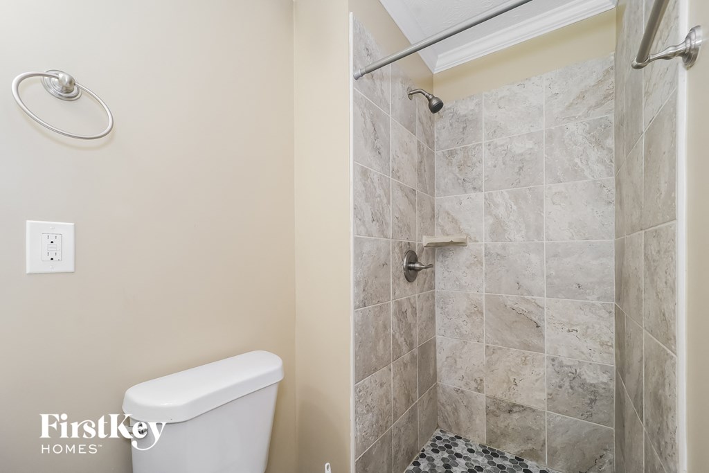 a small bathroom with a shower and a toilet