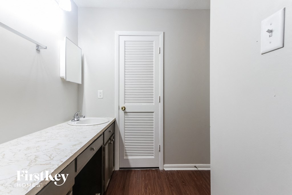 a small bathroom with a sink and a white door
