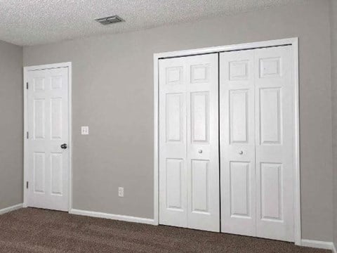 a living room with three white doors