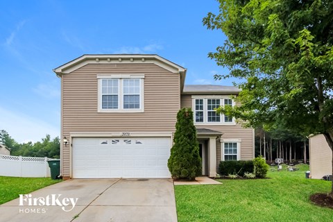 a beige house with a white garage door