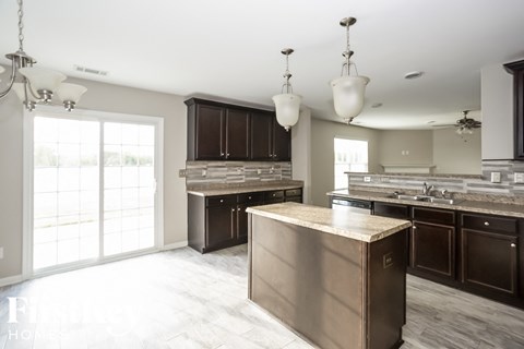 A kitchen with a large island in the middle.