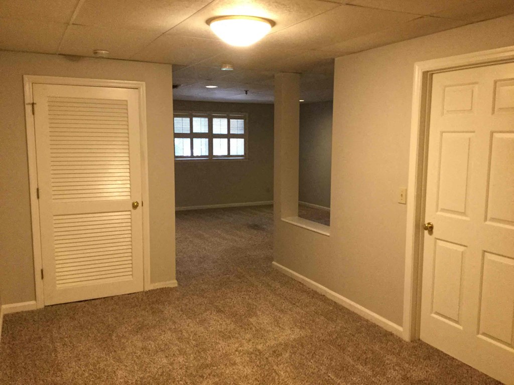an empty room with a closet and a door